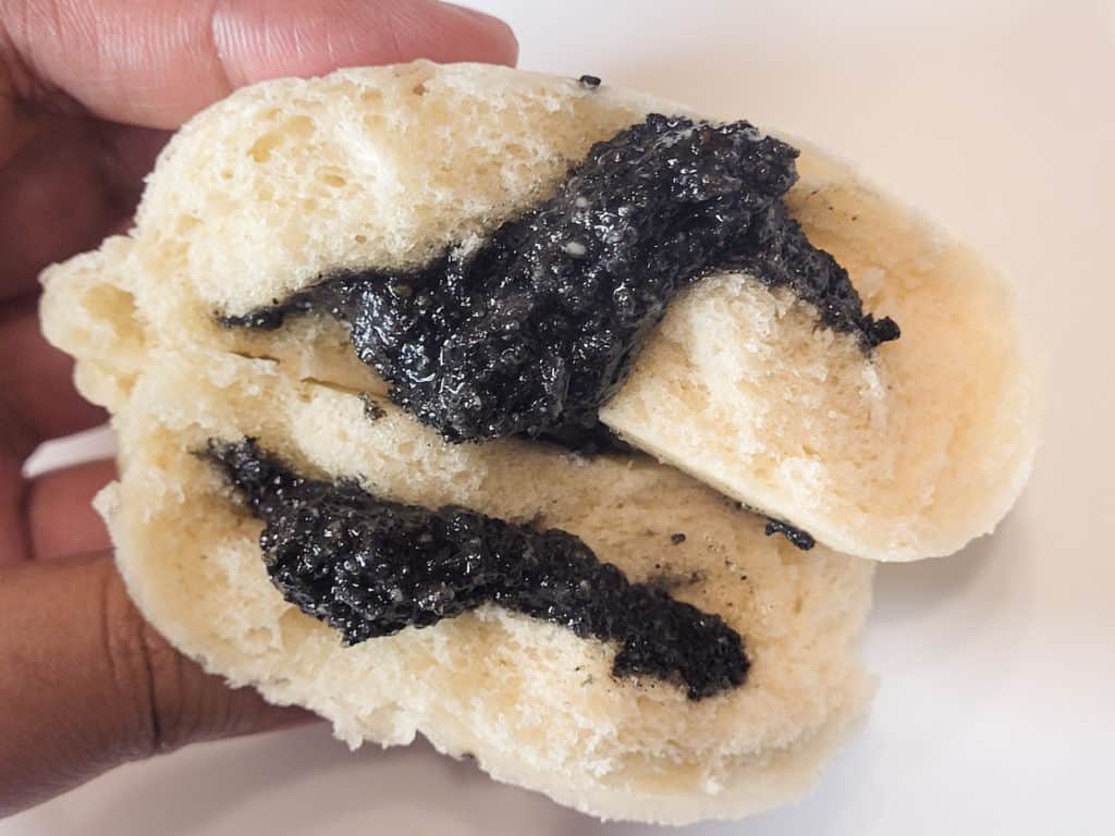 A cross section view of black sesame seed bun