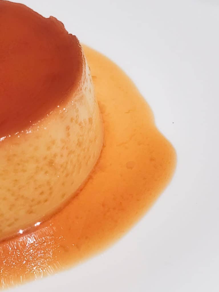A closeup image of Filipino style flan with a lot of bubbles.