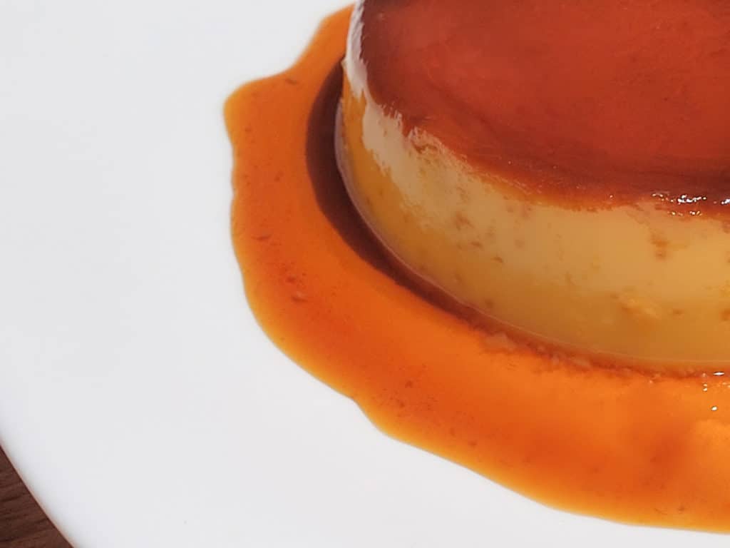 Side view of a FIlipino style flan with some bubbles