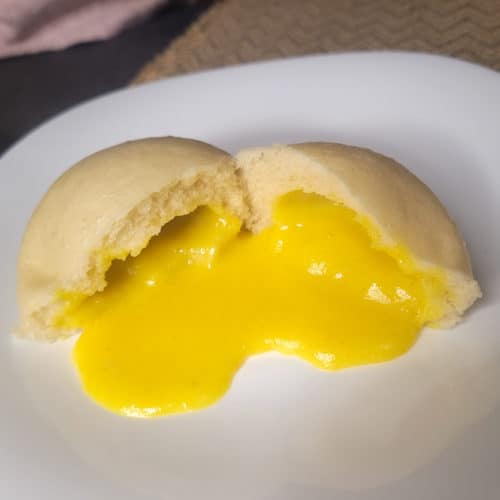 A closeup of salted egg yolk lava bun