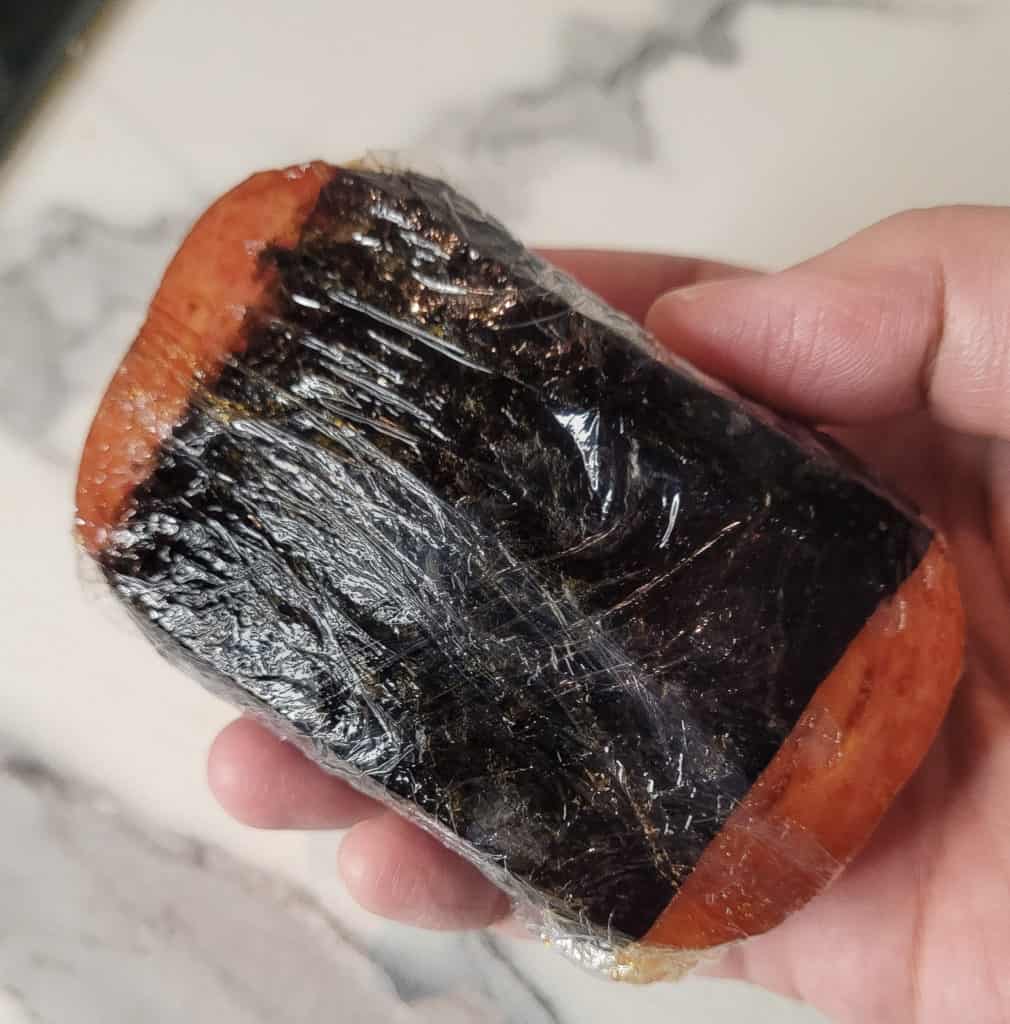A close up of wrapped spam musubi in clingfilm