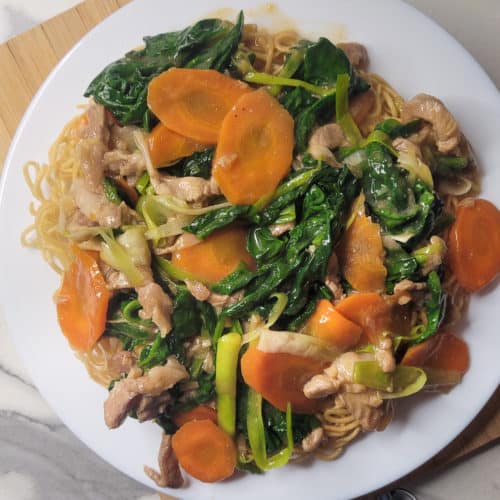 Plate of crispy pan friend noodles and vegetable topping