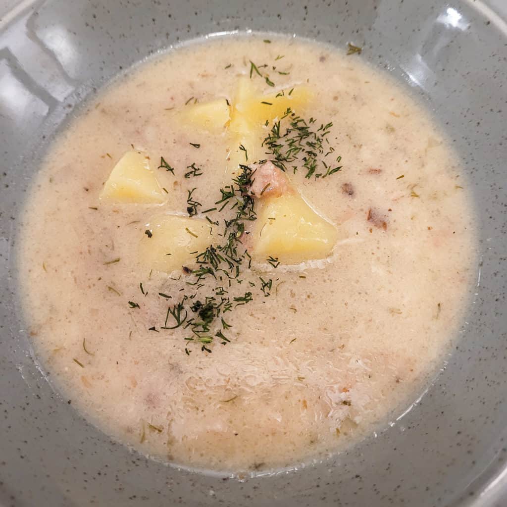 Closeup of a sourdough based soup in a gray bowl