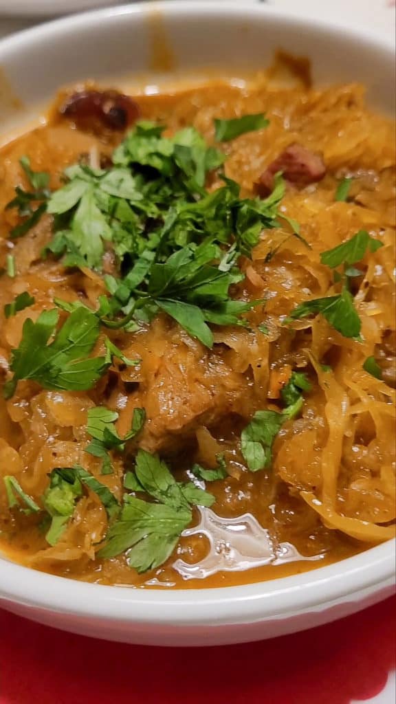 Closeup of Polish hunter's stew or bigos in a white bowl