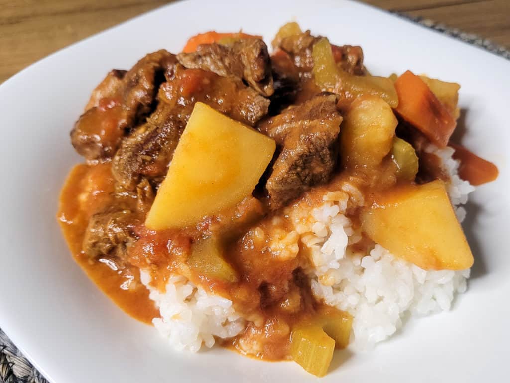 Local style beef stew on top of white rice