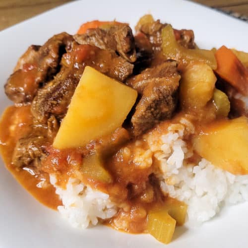 Local style beef stew on top of white rice