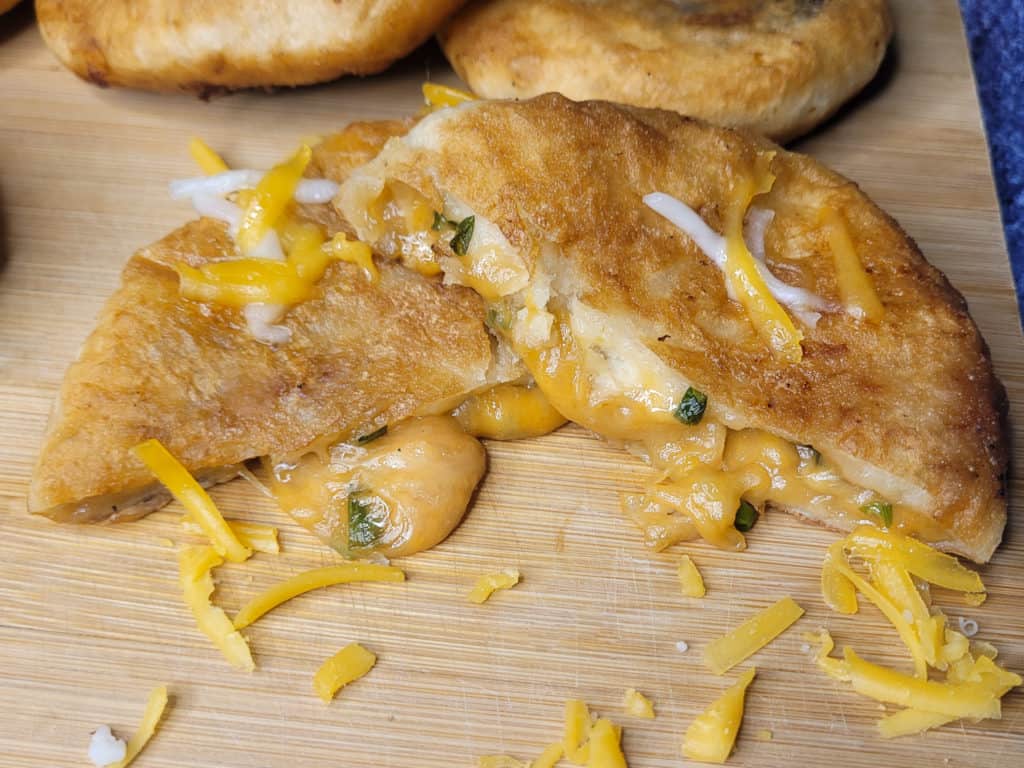 A close up of cheese hotteok on a board