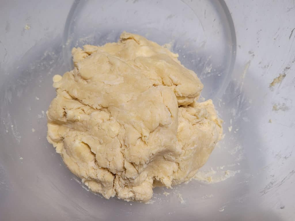 Rough pastry dough lump in a plastic bowl