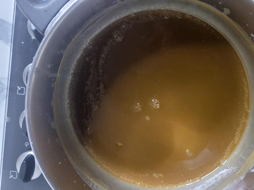 Caramel sauce in a silver pot