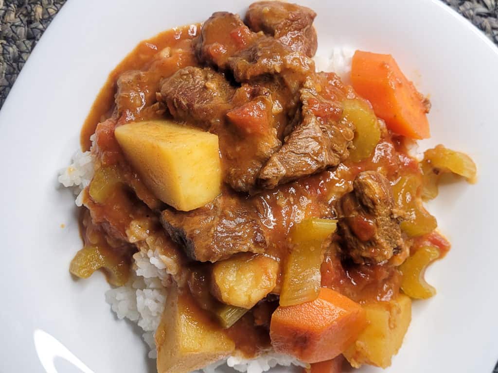 An overhead view of stew with carrots, potatoes, celery, and beef