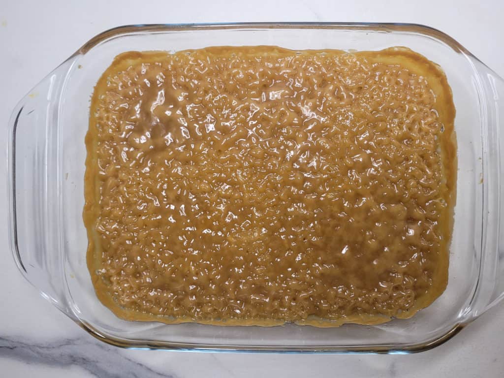 Overhead shot of biko, a Filipino rice dessert, in a glass baking pan