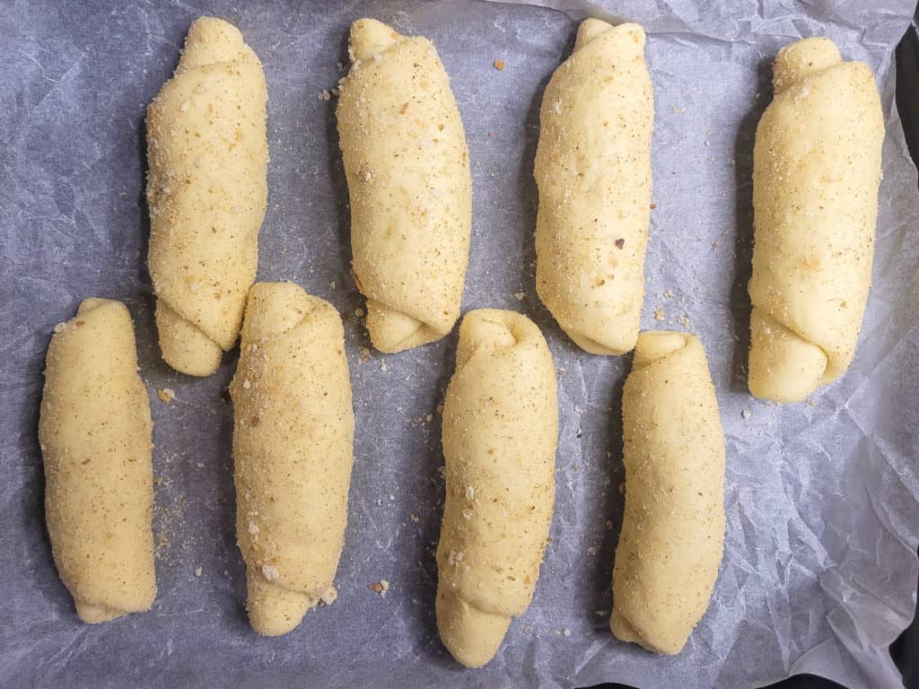 Filipino Spanish bread rolls on a line baking sheet