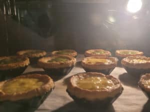 Portuguese egg tarts baking in the oven
