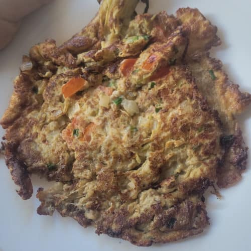 Vegetable filled tortang talong on a white plate