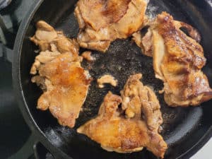 Cut chicken in cast iron skin side up