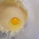 Filipino-style coconut macaroon batter with egg in bowl