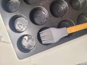 Muffin pan with vegetable oil and silicone brush