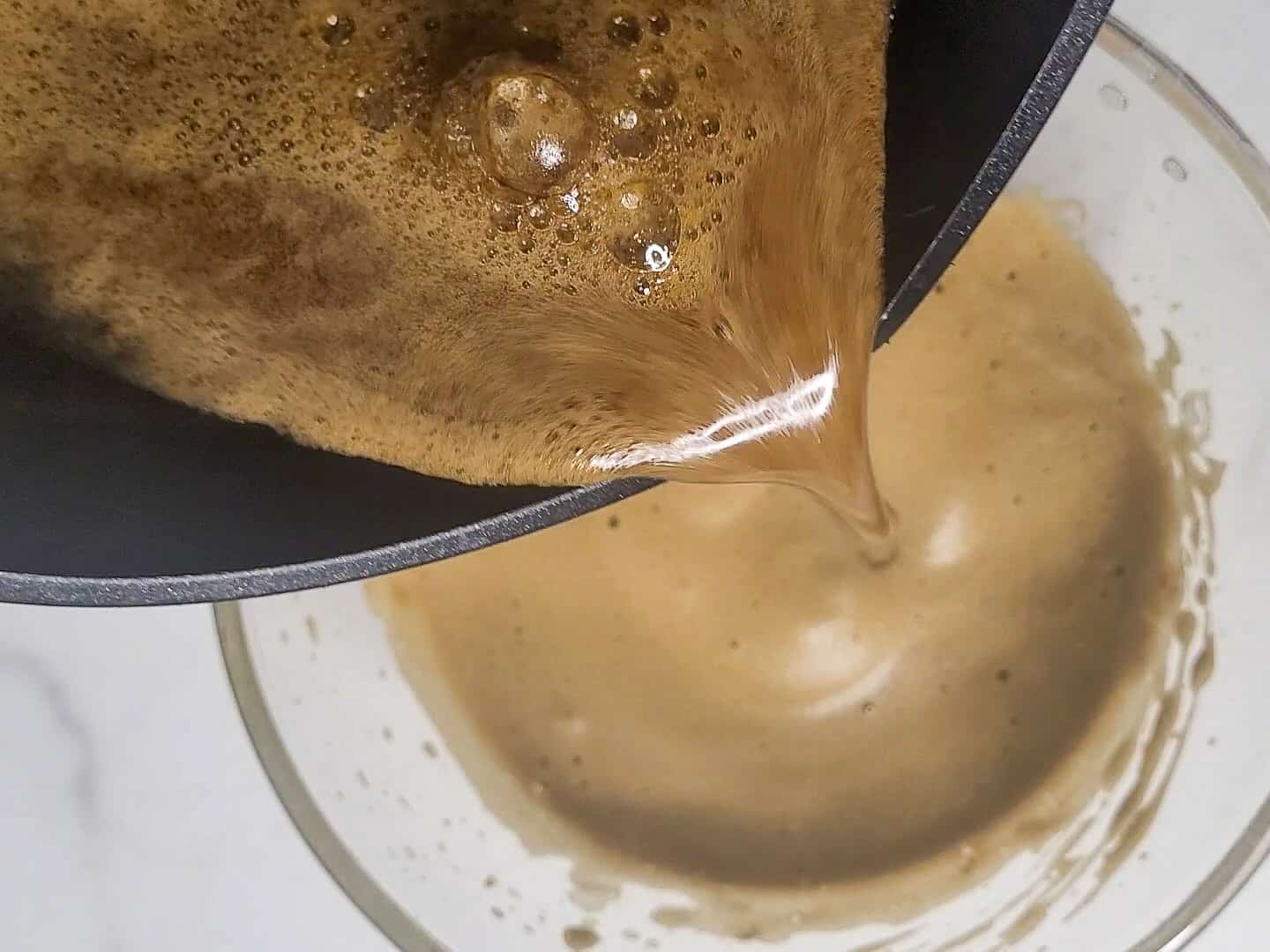 Coffee syrup being poured in a bowl