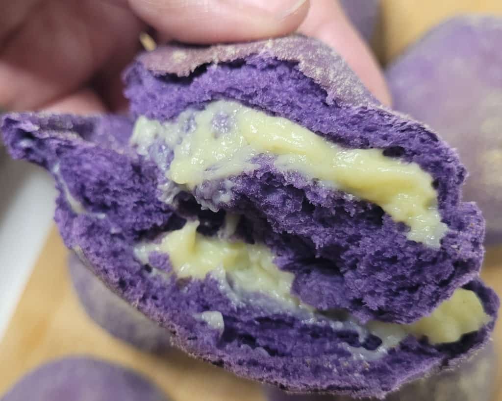 Cross section of ube pandesal with custard filling