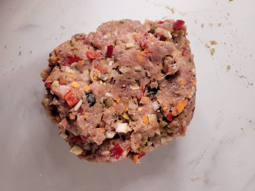 Mixed raw meat in a clear bowl