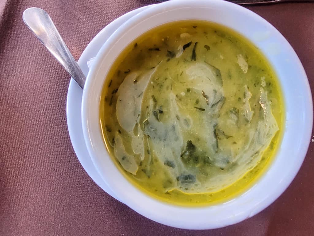 Lunch in Porto: Bowl of caldo verde or green soup on a red towel