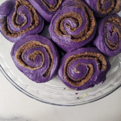 Closeup of ube rolls in a buttered pan