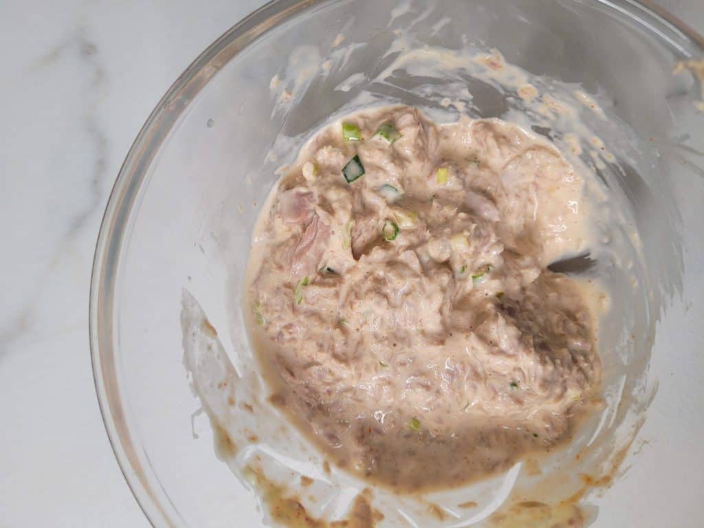 Closeup of mixed spicy tuna in a clear bowl