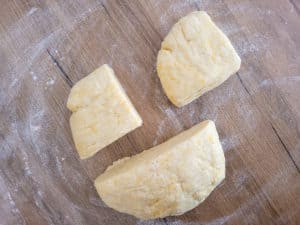 Sliced empanada dough on a floured surface