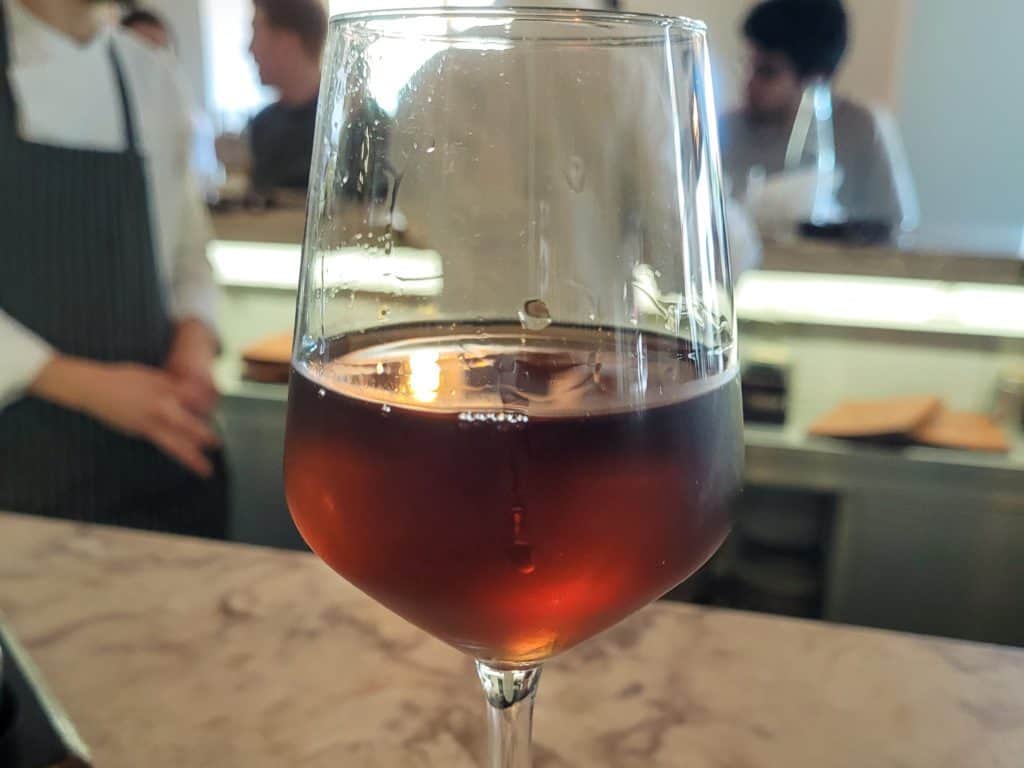 Wine on a countertop with people in the background