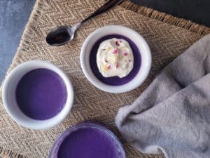 Overhead of ube pot de creme on a rustic placemat