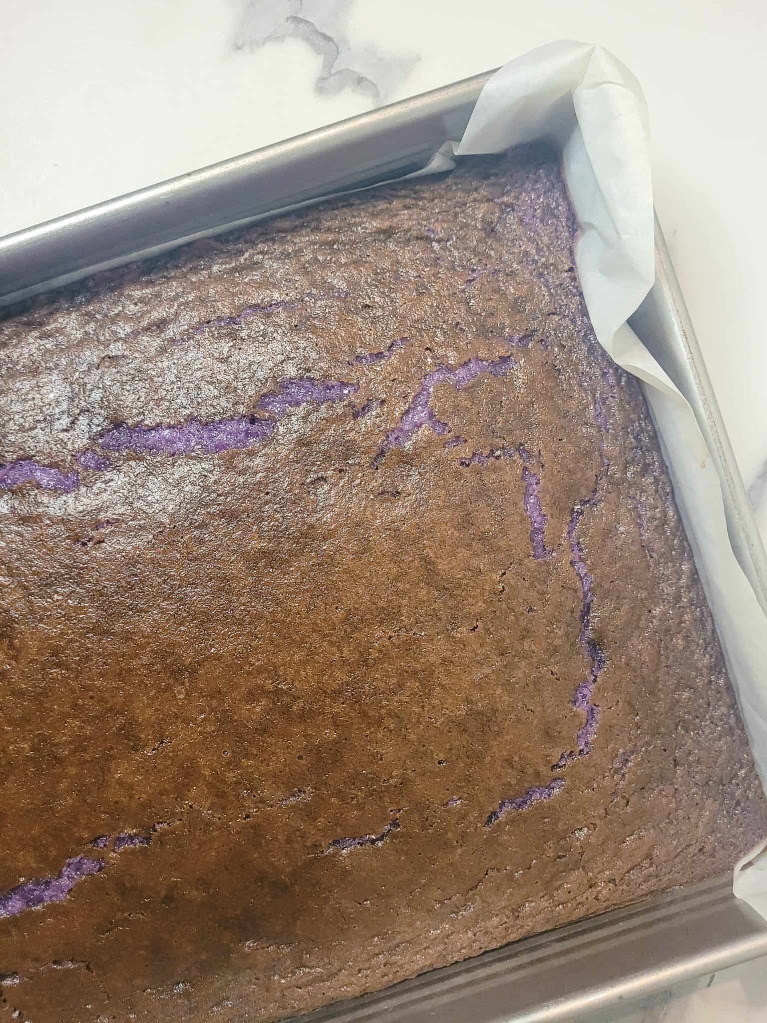 Baked ube butter mochi in a pan