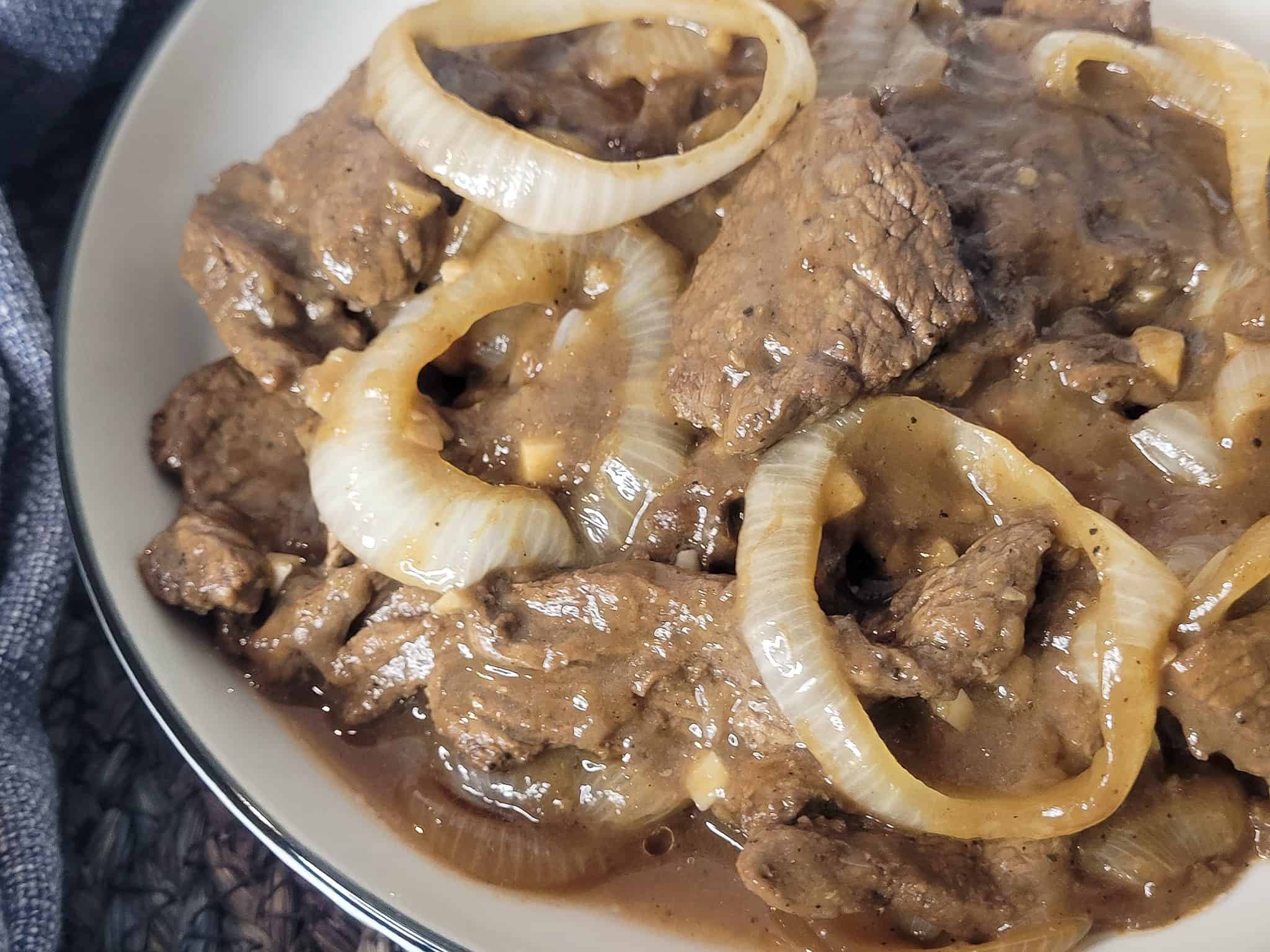 Closeup of Bistek tagalog or Filipino beefsteak