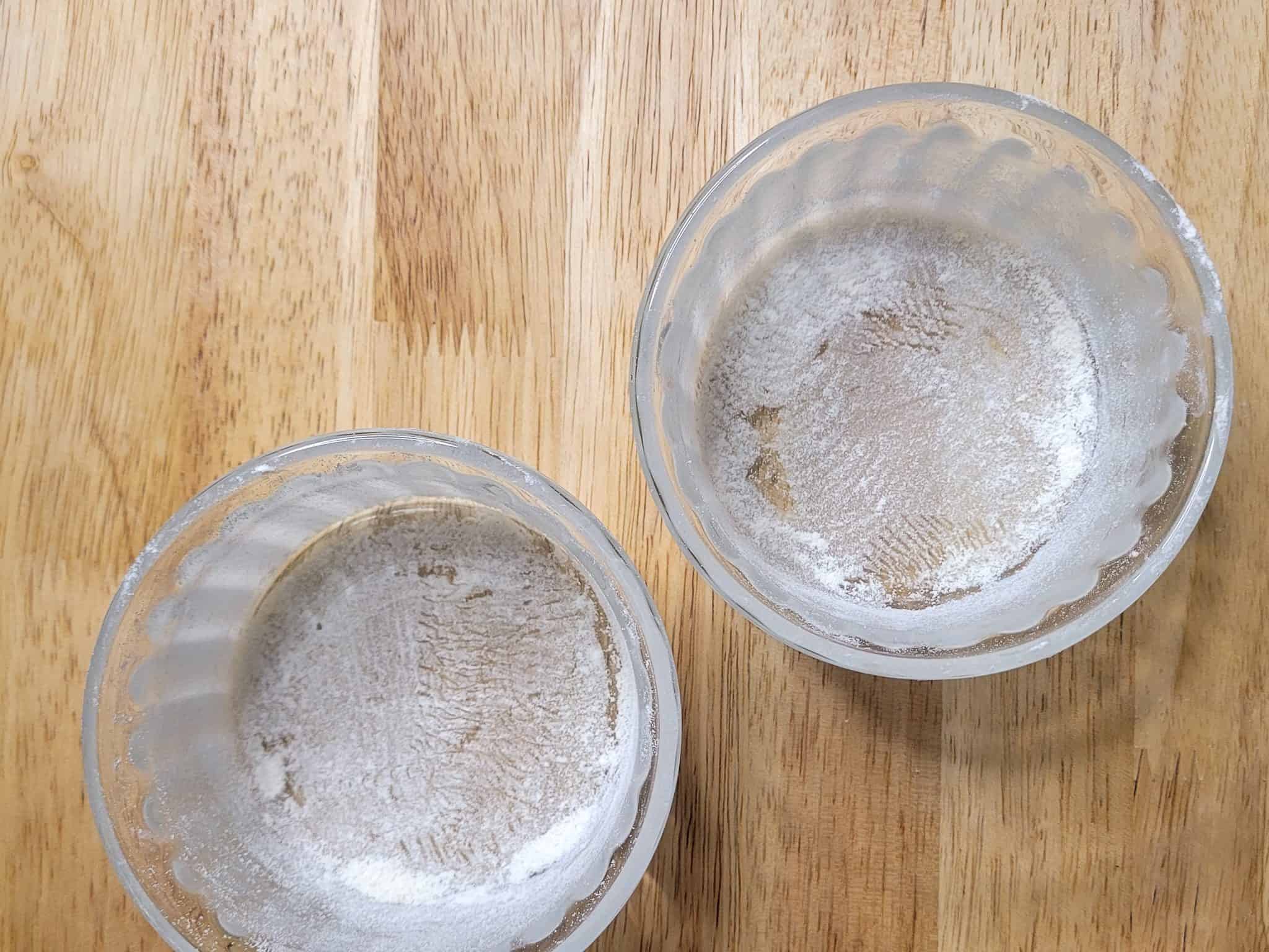 Floured ramekins on a wood table