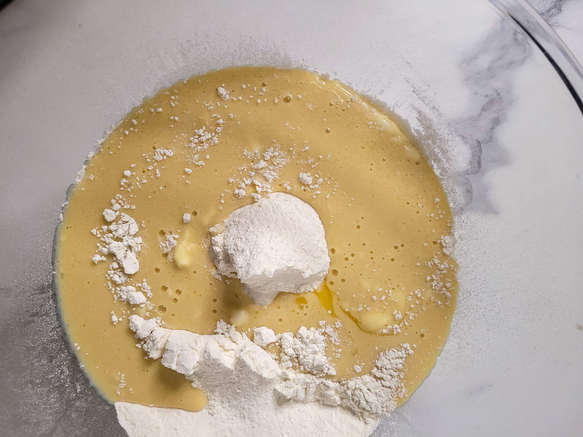 Wet and dry ingredients for ube mini buns in one bowl