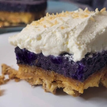 Ube crunch cake close up with whipped cream