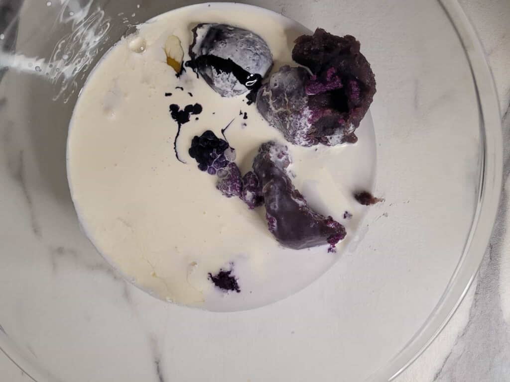 Ube crunch cake ingredients in a glass bowl