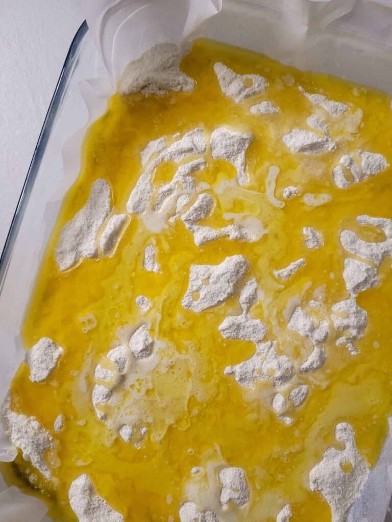Melted butter on top to dry cake mix in baking dish