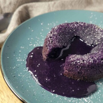 Closeup of ube lava cake on a blue plate