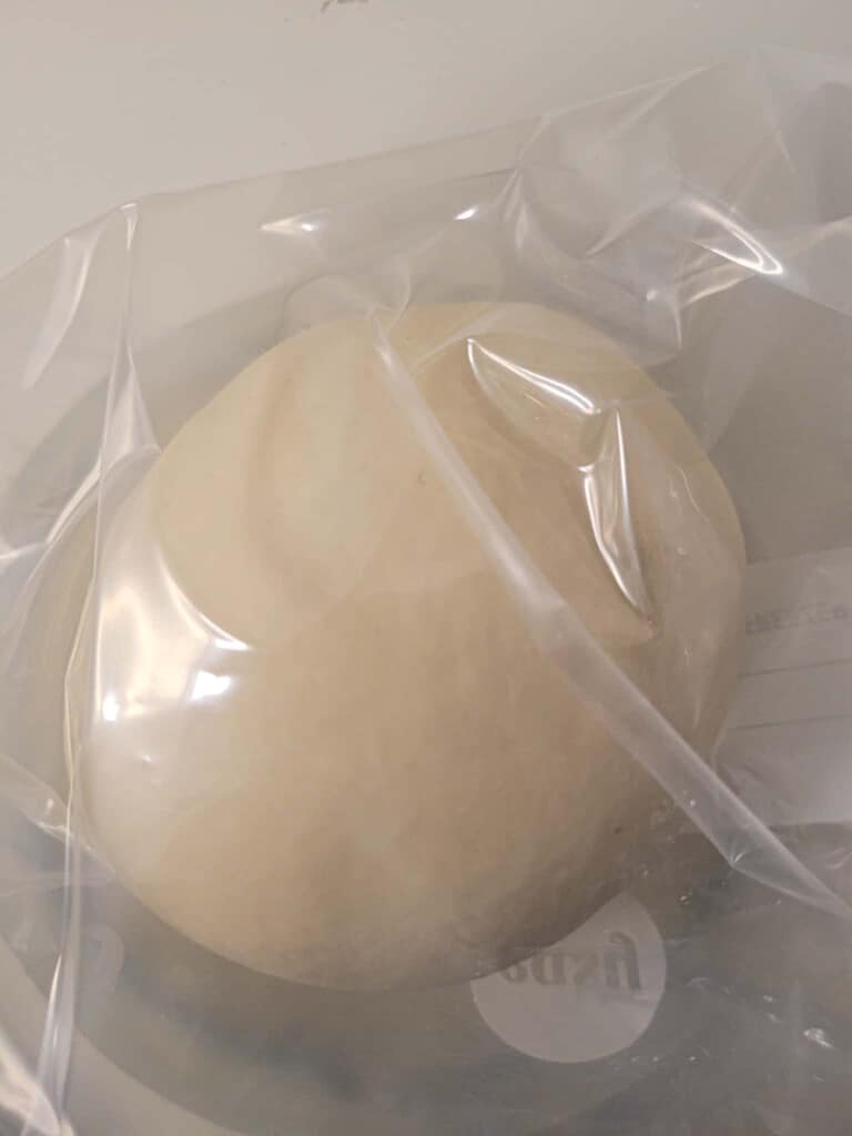 A ball of dough inside a plastic bag