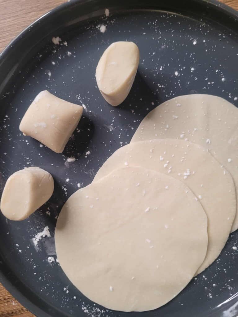 Dumpling wrapper pieces on a gray plate