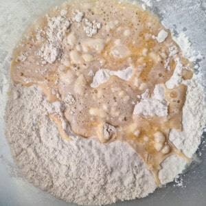 Yeast mixture on a bowl of flour
