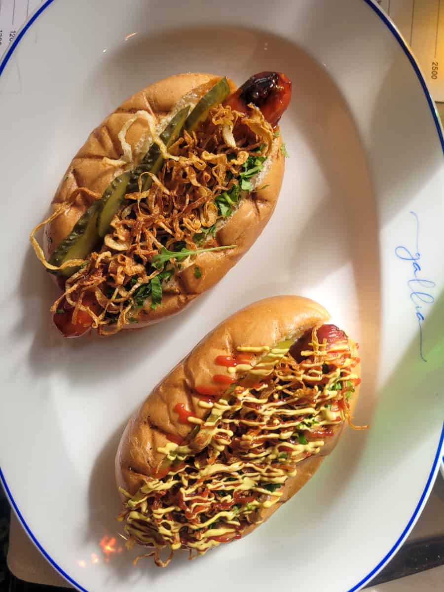 Two hotdogs on a white plate