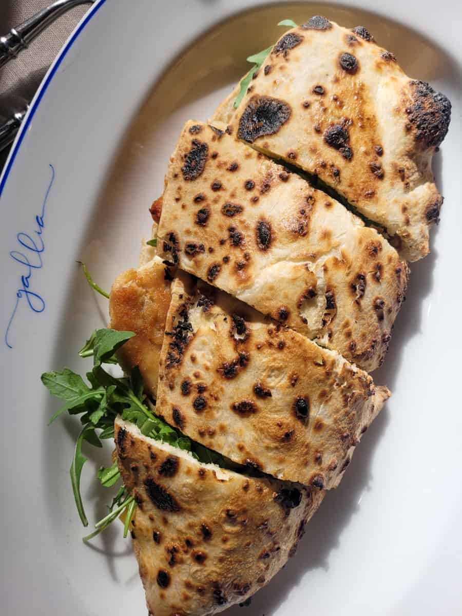 Closeup of chicken flatbread chicken on a white plate