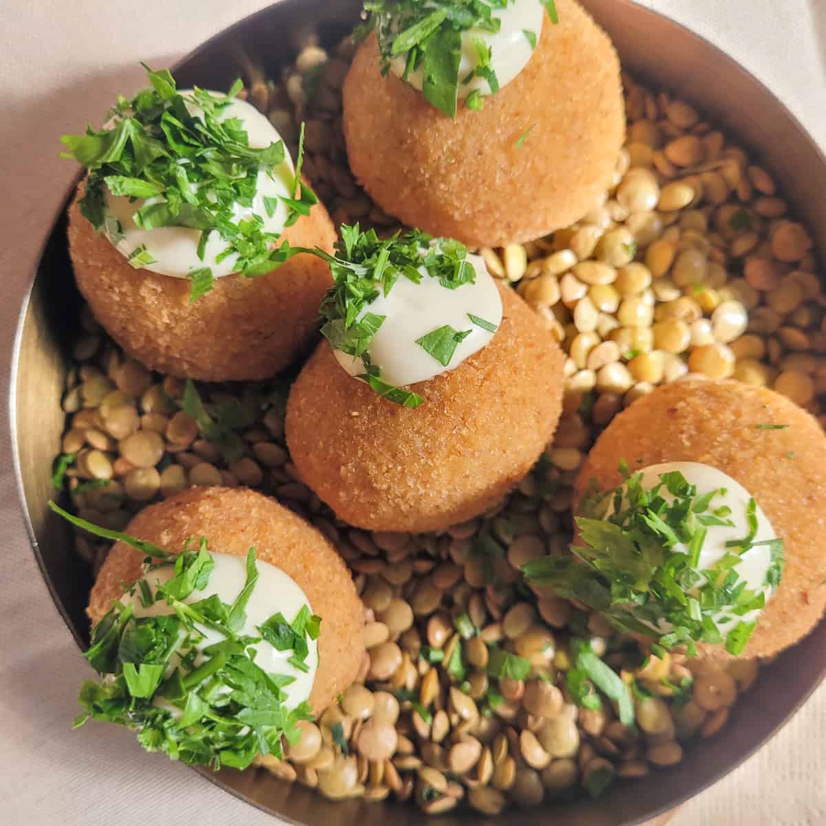 Rice balls on top of lentils in a bowl
