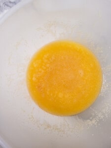 Bowl of mixed sugar, eggs, and melted butter