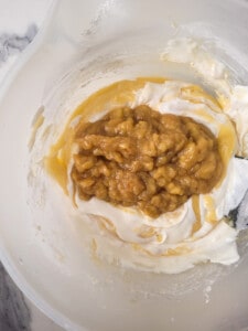 Mushed caramelized bananas with sour cream in a bowl