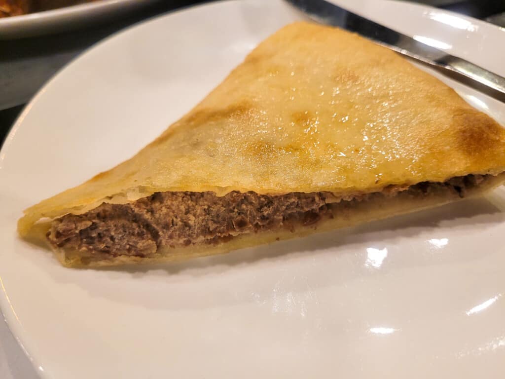 Lobiani, bean stuffed Georgian bread, on a white plate