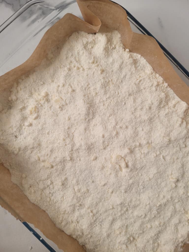 Flour in a baking dish with parchment paper