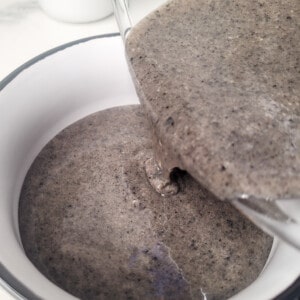 Black sesame white chocolate ganache poured into a small bowl