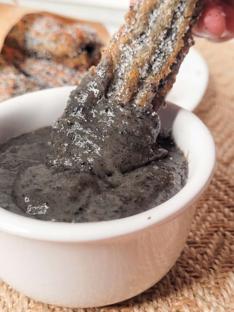 Churros dipped in black sesame ganache